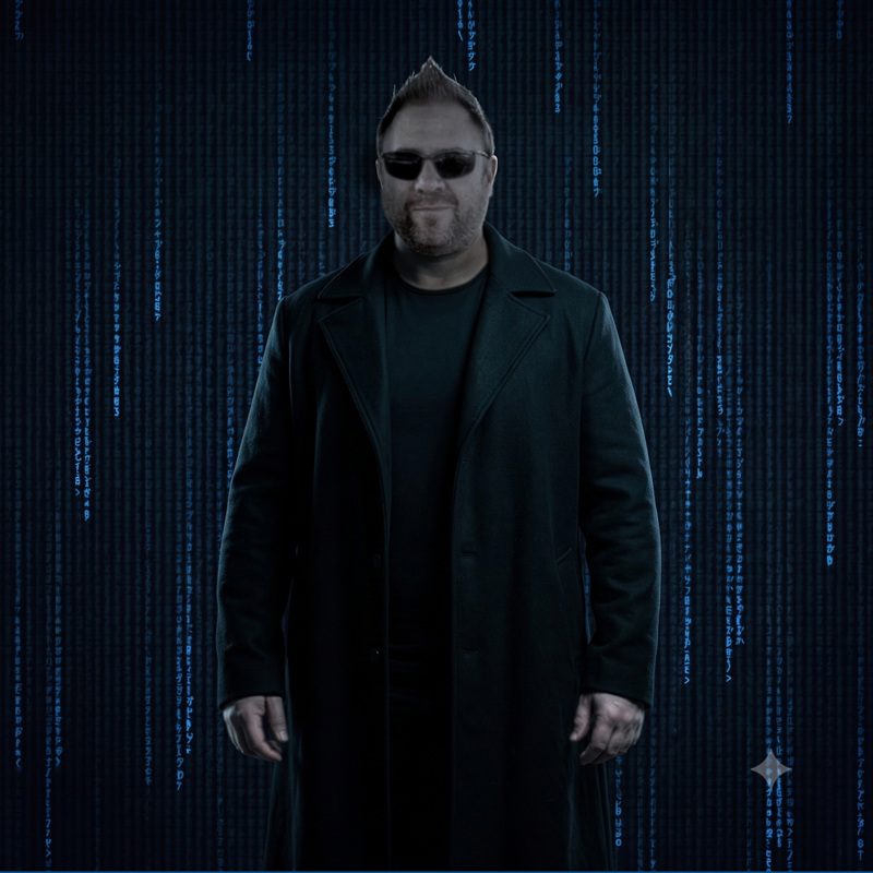 Warren against a Matrix-style background of blue digital text rain