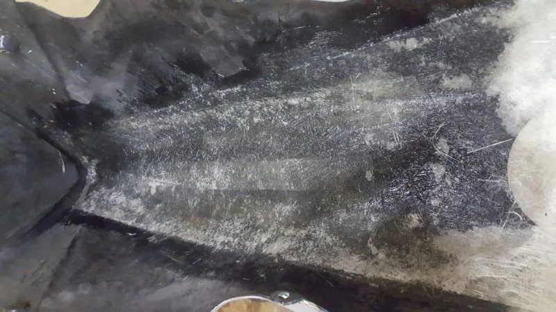 Resin being worked into the fibreglass matting on the back of a panel