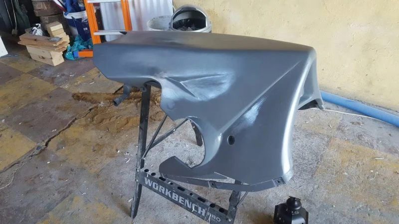 Fairing panels in grey primer, laid out in the garage
