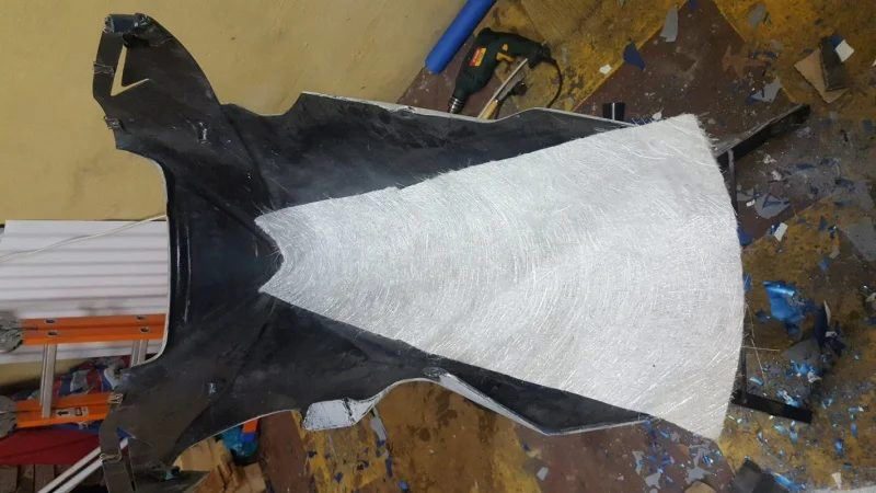 Fibreglass matting being measured against the inside of a fairing panel
