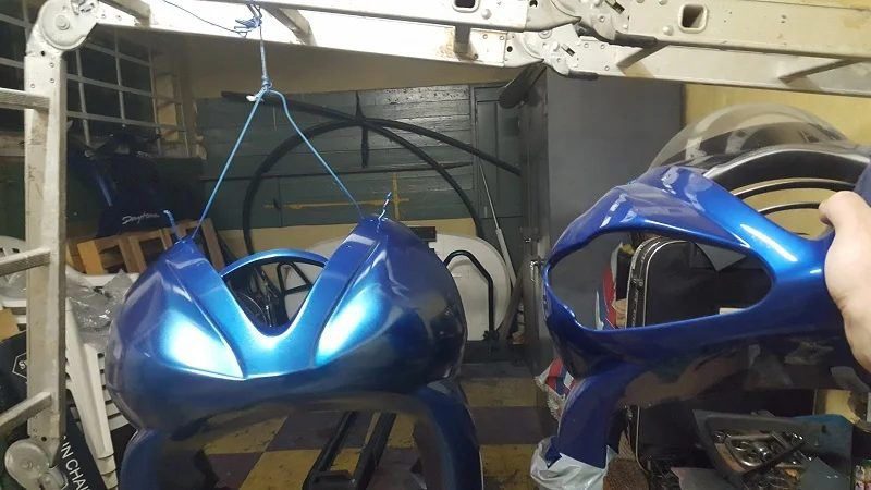 Two fairing panels hanging next to each other for colour comparison
