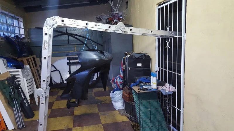 Fairing panels hanging from an improvised frame rigged up in a garage doorway