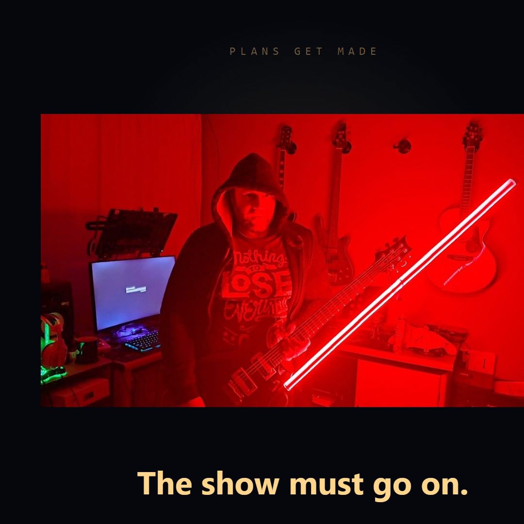 Warren on stage in a hood, playing a guitar whose extended neck glows like a red lightsaber, above the words "The show must go on"
